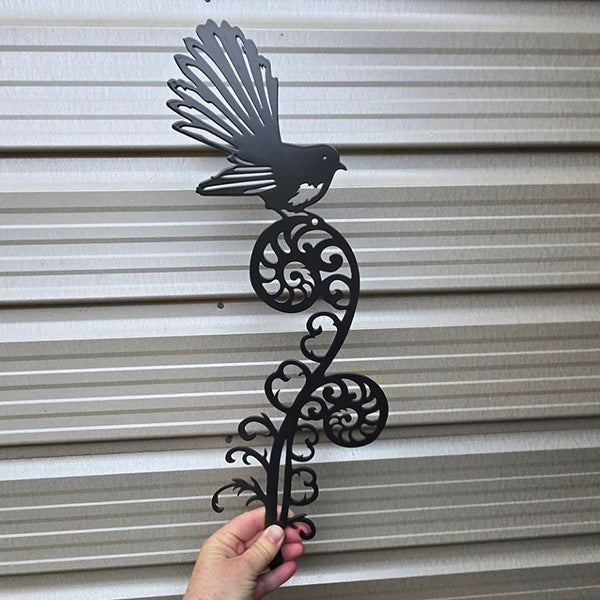 fantail on koru